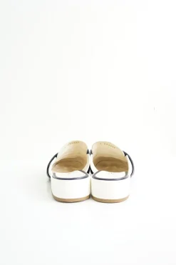 Navy and white quilted leather square-toe mules with beaded Coco Mark at vamp