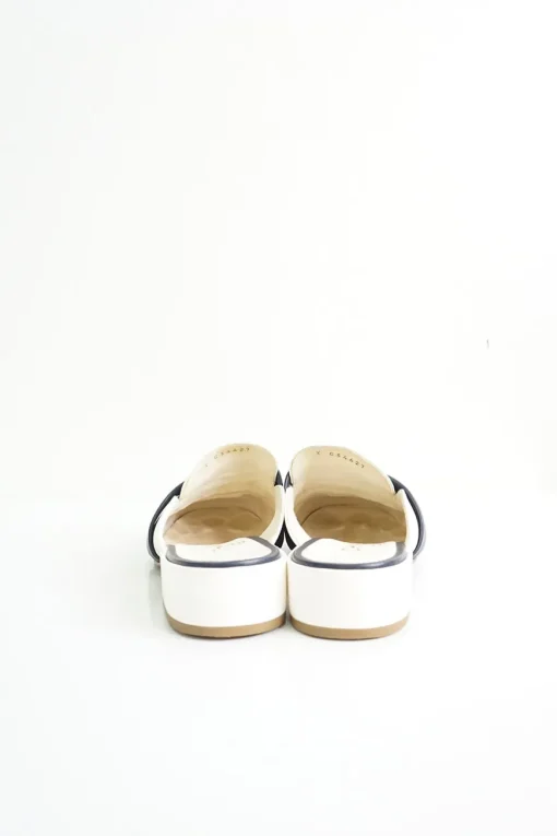 Navy and white quilted leather square-toe mules with beaded Coco Mark at vamp