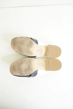 Navy and white quilted leather square-toe mules with beaded Coco Mark at vamp