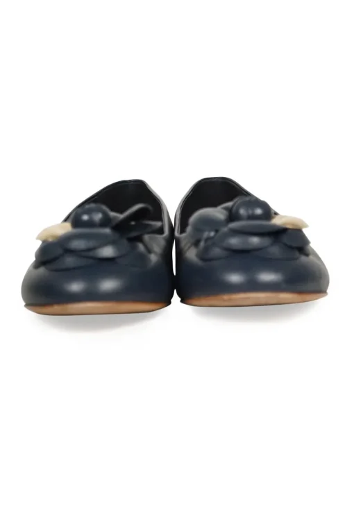 Navy calfskin camellia ballerinas with contrast metallic petal and brand-signature Coco Mark plaque