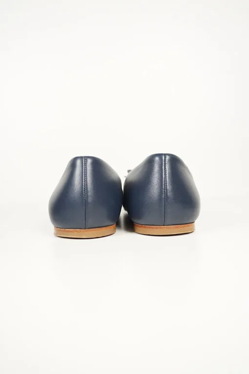 Navy calfskin camellia ballerinas with contrast metallic petal and brand-signature Coco Mark plaque