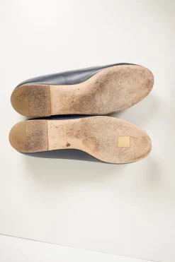 Navy calfskin camellia ballerinas with contrast metallic petal and brand-signature Coco Mark plaque
