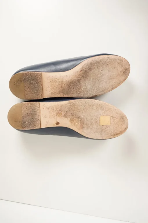 Navy calfskin camellia ballerinas with contrast metallic petal and brand-signature Coco Mark plaque
