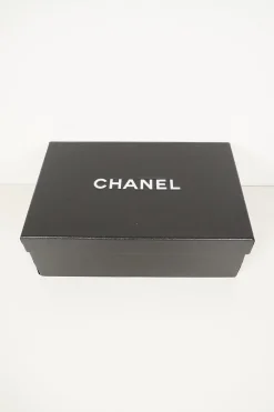 Navy calfskin camellia ballerinas with contrast metallic petal and brand-signature Coco Mark plaque