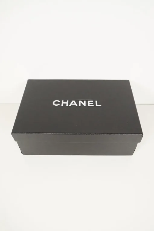 Navy calfskin camellia ballerinas with contrast metallic petal and brand-signature Coco Mark plaque