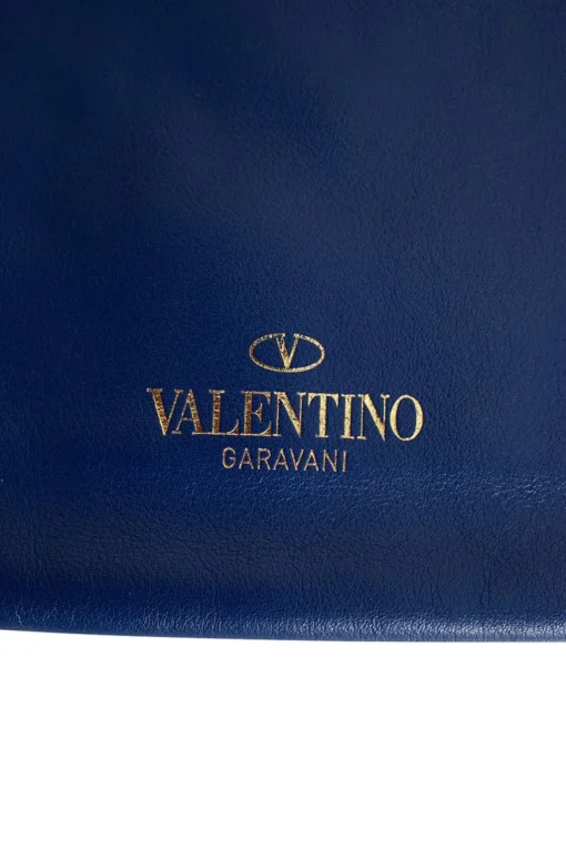 Navy clutch with wrist strap and brand stamp