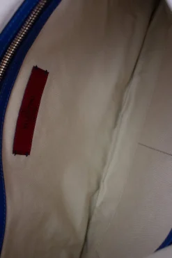 Navy clutch with wrist strap and brand stamp