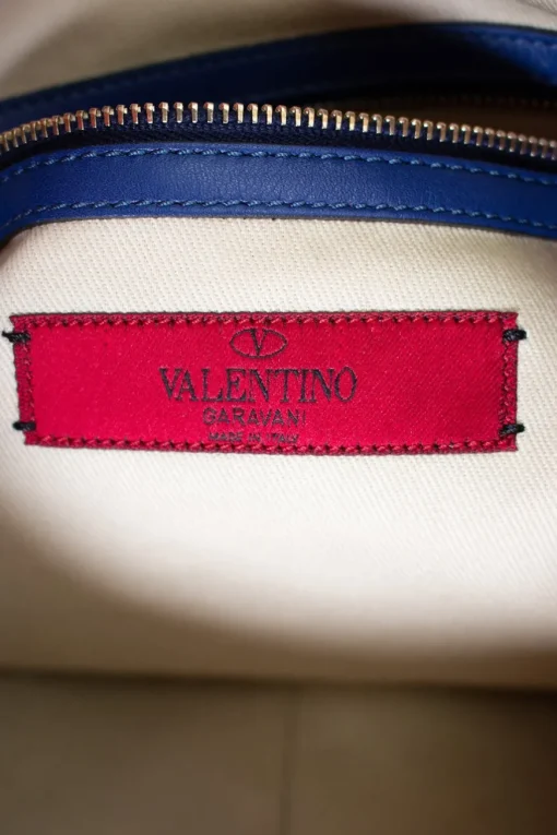 Navy clutch with wrist strap and brand stamp