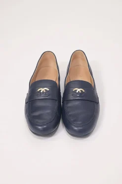 Navy leather penny-style slip-on loafers featuring silver-finish metallic Coco Mark plaque