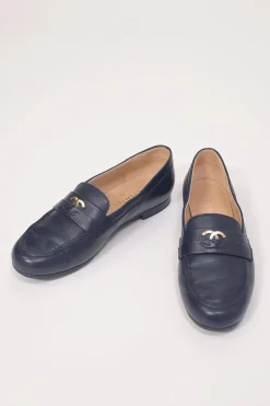 Navy leather penny-style slip-on loafers featuring silver-finish metallic Coco Mark plaque