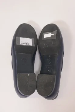 Navy leather penny-style slip-on loafers featuring silver-finish metallic Coco Mark plaque