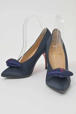 Navy satin pointed toe pumps featuring pillowed top accents