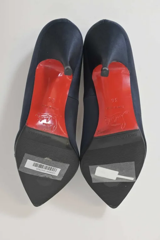 Navy satin pointed toe pumps featuring pillowed top accents