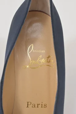 Navy satin pointed toe pumps featuring pillowed top accents