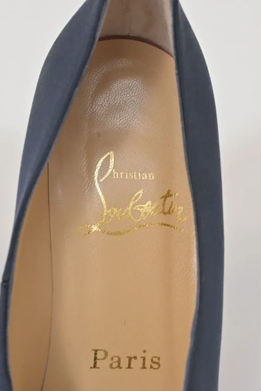 Navy satin pointed toe pumps featuring pillowed top accents