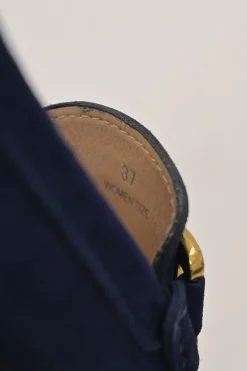 Navy suede Kate round-toe slip-on driving loafers with branded chainlink vamp buckle appliqué and signature Gommino soles