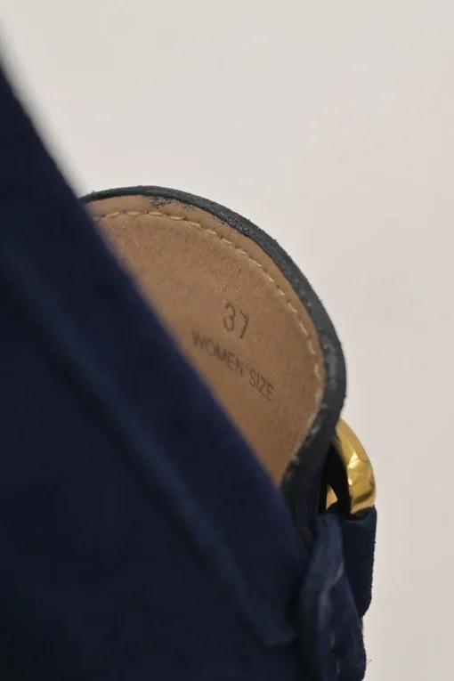 Navy suede Kate round-toe slip-on driving loafers with branded chainlink vamp buckle appliqué and signature Gommino soles