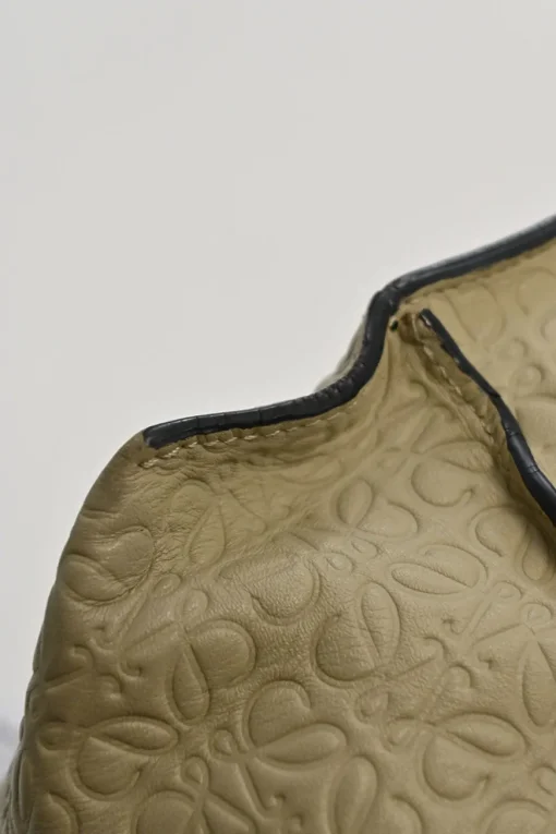 Neutral anagram-embossed leather tote with detachable shoulder strap