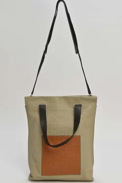 Neutral anagram-embossed leather tote with detachable shoulder strap