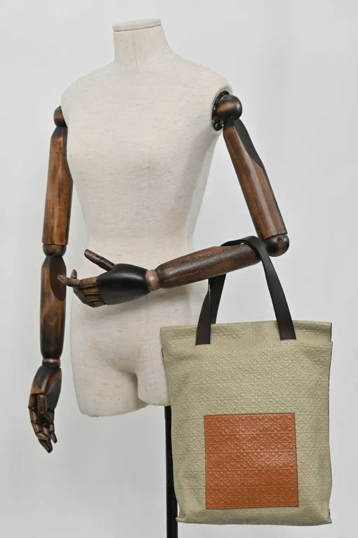 Neutral anagram-embossed leather tote with detachable shoulder strap