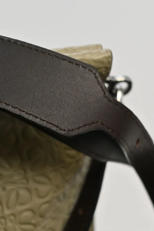 Neutral anagram-embossed leather tote with detachable shoulder strap