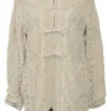 Neutral cable knit hooded zip-up cardigan with show frog button detailing at centre front