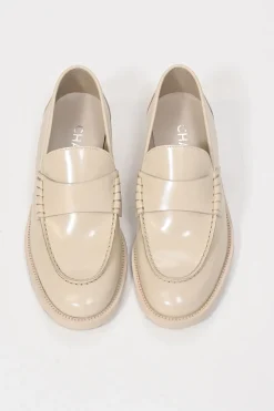 Nude brushed calfskin loafers featuring silver-finish metal logo lettering on heel