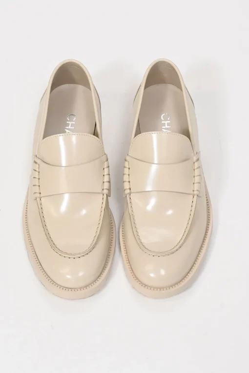Nude brushed calfskin loafers featuring silver-finish metal logo lettering on heel
