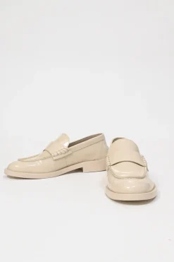Nude brushed calfskin loafers featuring silver-finish metal logo lettering on heel