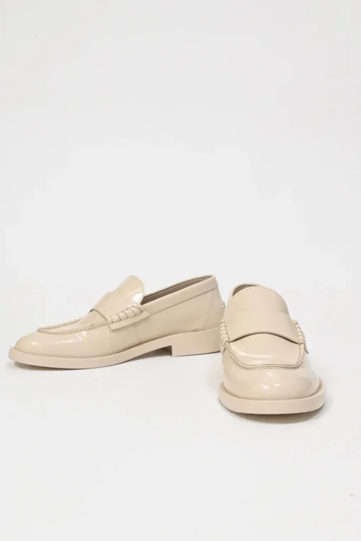 Nude brushed calfskin loafers featuring silver-finish metal logo lettering on heel