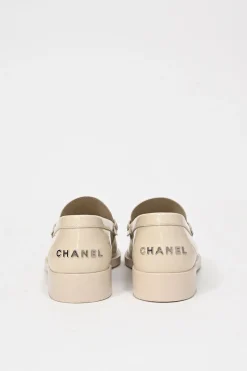 Nude brushed calfskin loafers featuring silver-finish metal logo lettering on heel