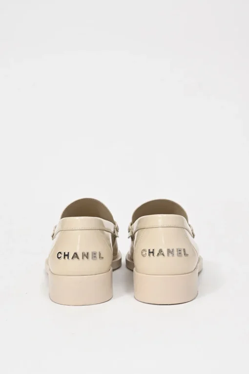 Nude brushed calfskin loafers featuring silver-finish metal logo lettering on heel