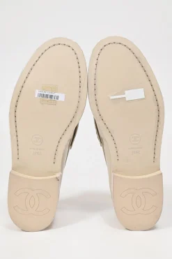 Nude brushed calfskin loafers featuring silver-finish metal logo lettering on heel