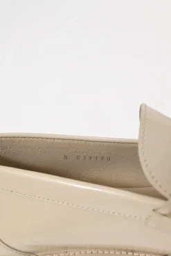 Nude brushed calfskin loafers featuring silver-finish metal logo lettering on heel