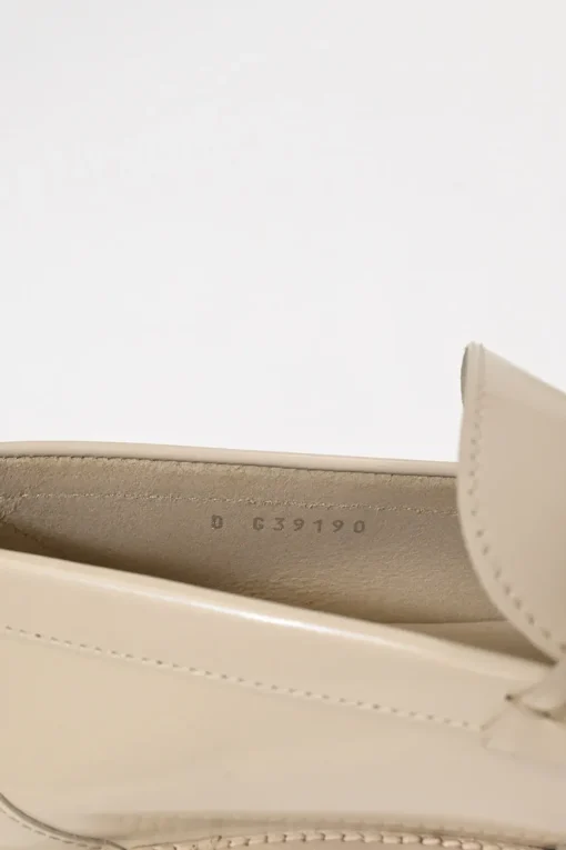 Nude brushed calfskin loafers featuring silver-finish metal logo lettering on heel