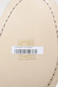 Nude brushed calfskin loafers featuring silver-finish metal logo lettering on heel