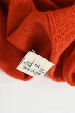 Orange cashmere jersey knit two-piece set with sleeveless turtleneck and crewneck button-front cardigan