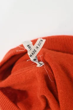 Orange cashmere jersey knit two-piece set with sleeveless turtleneck and crewneck button-front cardigan