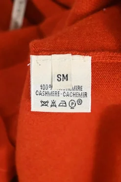 Orange cashmere jersey knit two-piece set with sleeveless turtleneck and crewneck button-front cardigan