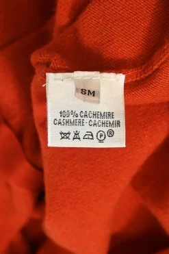 Orange cashmere jersey knit two-piece set with sleeveless turtleneck and crewneck button-front cardigan