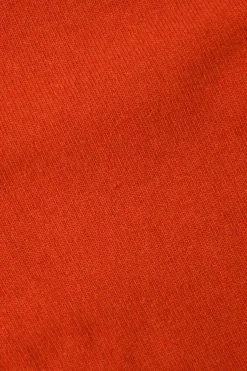 Orange cashmere jersey knit two-piece set with sleeveless turtleneck and crewneck button-front cardigan