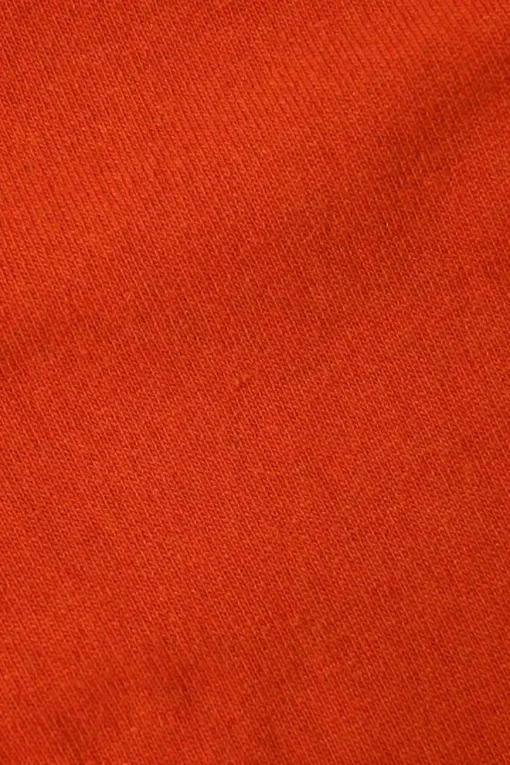 Orange cashmere jersey knit two-piece set with sleeveless turtleneck and crewneck button-front cardigan