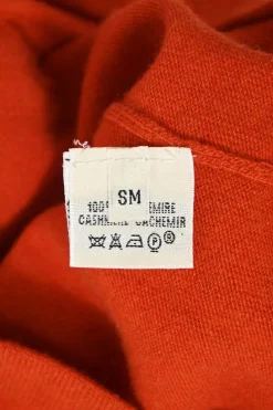 Orange cashmere jersey knit two-piece set with sleeveless turtleneck and crewneck button-front cardigan