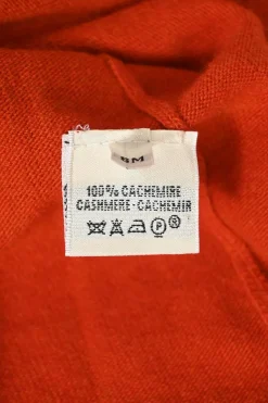Orange cashmere jersey knit two-piece set with sleeveless turtleneck and crewneck button-front cardigan