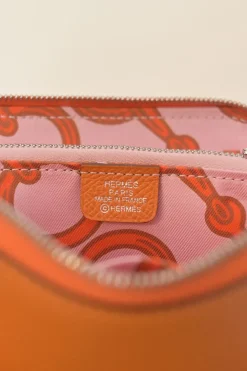 Orange Epsom leather Silk'In change purse featuring Henri d'Origny's 'Mors &amp; Co' printed lining