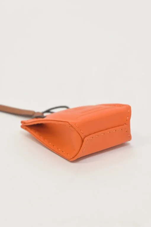 Orange Feu Milo and gold Swift shopping bag charm