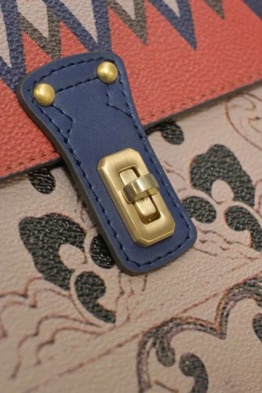 Orange grained printed leather turnlock flap envelope clutch featuring painterly floral motif