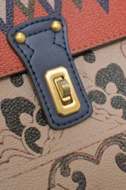 Orange grained printed leather turnlock flap envelope clutch featuring painterly floral motif