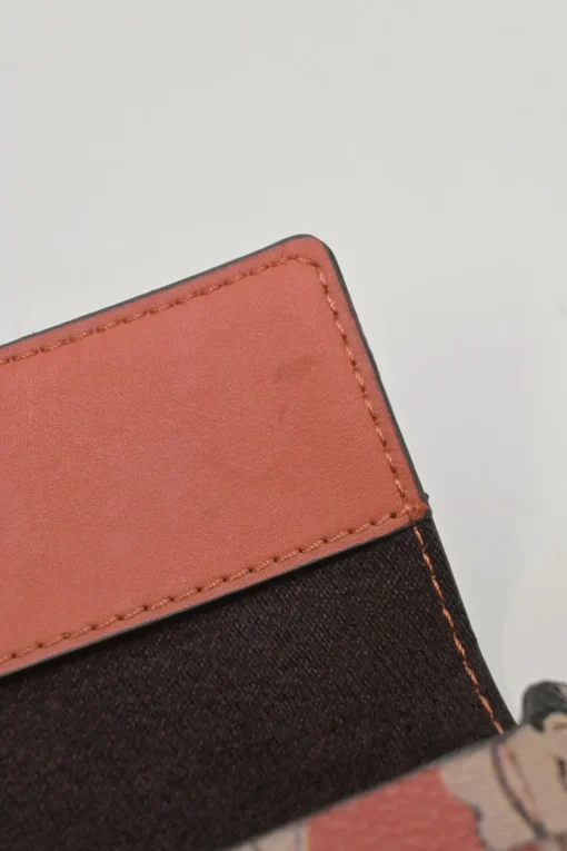 Orange grained printed leather turnlock flap envelope clutch featuring painterly floral motif