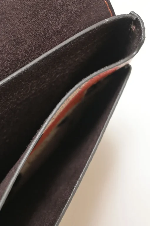 Orange grained printed leather turnlock flap envelope clutch featuring painterly floral motif